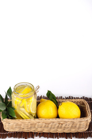 lemonade with some uncut lemon inside a basket ready copy spaceの写真素材