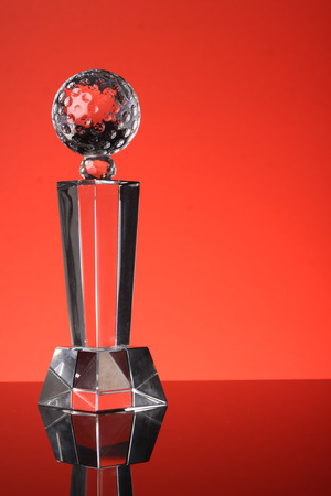 glass trophy in red backgroundの写真素材