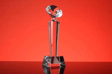 glass trophy in red backgroundの写真素材