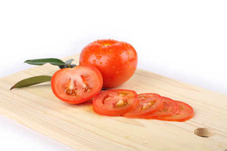 slices of tomatoes on a wooden boardの写真素材