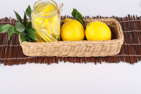 lemonade with some uncut lemon inside a basket ready copy spaceの写真素材