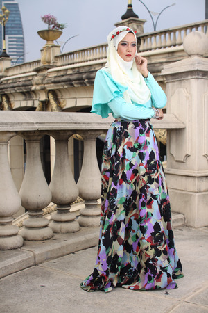 high fashion muslim woman posing at bridgeの写真素材