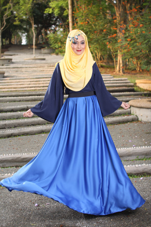 high fashion muslim woman posing at wooden backgroundの写真素材