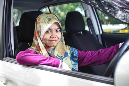 potrait of muslim woman driving her car