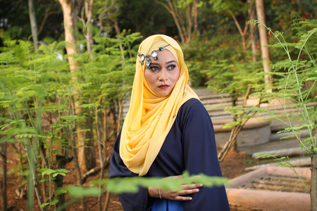 high fashion muslim women posing with nature backgroundの写真素材
