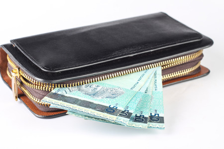 black purse with malaysian money isolated on white backgroundの写真素材