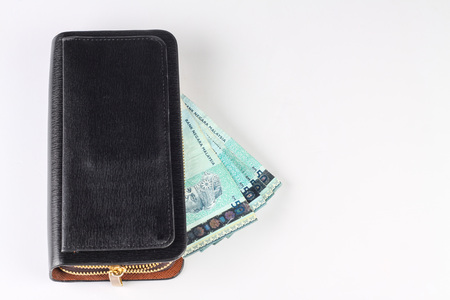 black purse with malaysian money isolated on white backgroundの写真素材