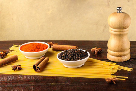 spices with spaghetti isolated on wooden backgroundの写真素材