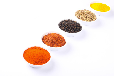 various spices selection focusing on black pepper isolated on white backgroundの写真素材