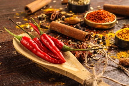 various spices selection focused on chili infront on wooden backgroundの写真素材