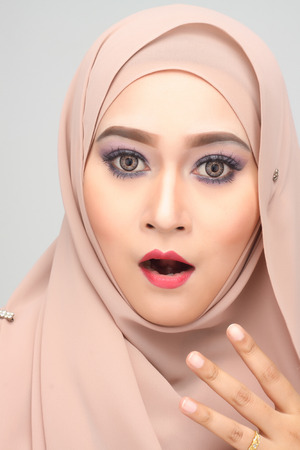 young asian muslim woman with shock expression wearing hijabの写真素材