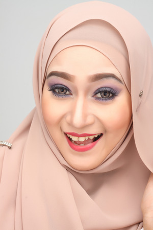 young asian muslim woman with happy expression wearing hijabの写真素材