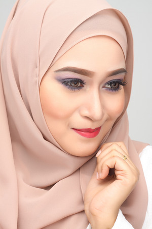 young asian muslim woman with expression wearing hijabの写真素材