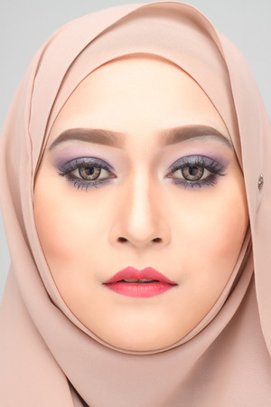young asian muslim woman with expression wearing hijabの写真素材