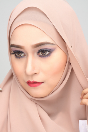young asian muslim woman with expression wearing hijabの写真素材