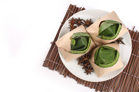 traditional fresh Malaysian nasi lemak packed with banana leaf in white backgroundの写真素材