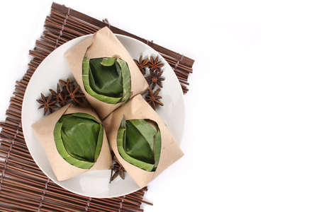 traditional fresh Malaysian nasi lemak packed with banana leaf in white backgroundの写真素材