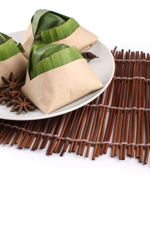 traditional fresh Malaysian nasi lemak packed with banana leaf in white backgroundの写真素材