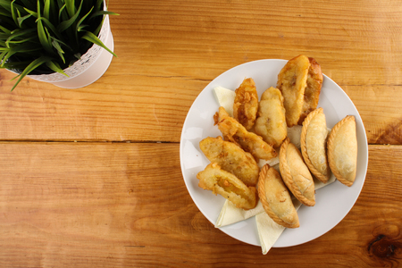 delicious Malaysian curry puff and crispy fried banana served on white plate on wood backgroundの写真素材