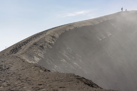People at the peak of Mount Bromo with some dust smoke came out from the craterの写真素材
