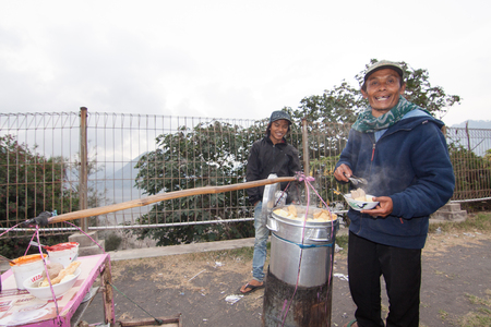 PENANJAKAN, INDONESIA - NOVEMBER 20 : Local buy and eat local food while viewing sunset of bromo from Penanjakan dua. Tourist is one of the main income at East Java, Indonesia 20 November 2015のeditorial素材