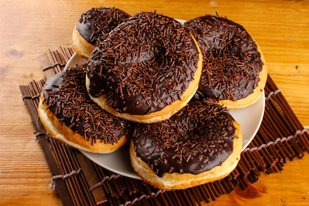 concept of chocolate doughnuts with wood palet backgroundの写真素材