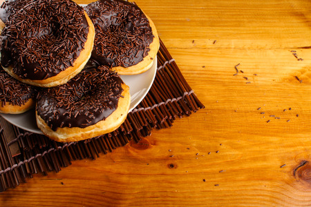 concept of chocolate doughnuts with wood palet backgroundの写真素材