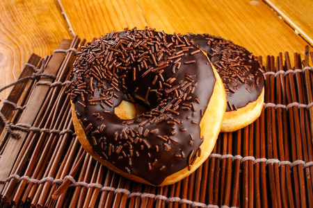 concept of chocolate doughnuts with wood palet backgroundの写真素材
