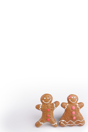 Gingerbread man and Gingerbread lady decorated colored icing. Holiday cookie in shape of man and lady isolated in white backgroundの写真素材