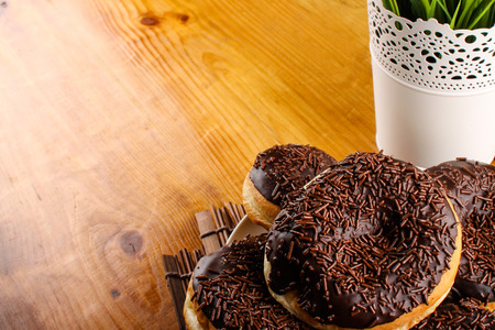 concept of chocolate doughnuts with wood palet backgroundの写真素材