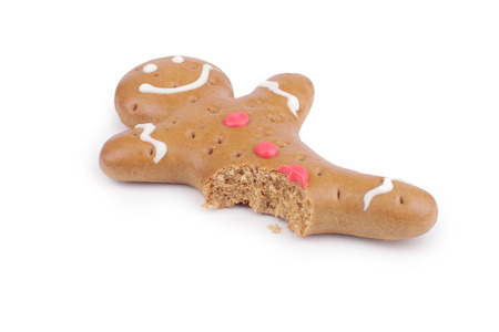 Gingerbread man decorated colored icing. Holiday cookie in shape of  man isolated in white backgroundの写真素材
