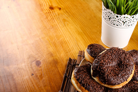 concept of chocolate doughnuts with wood palet backgroundの写真素材