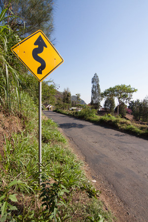 Road signage shows that the road ahead is not straight at Sukapaura, East Java Indonesia.の写真素材