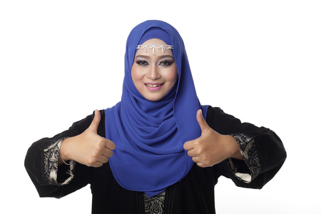 Malaysian malay woman showing good hand sign with smile expressionの写真素材