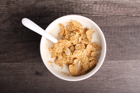 cereals with wood background and fresh milk