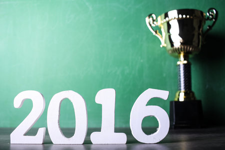 winning trophy with green calkboard background and 2016 text