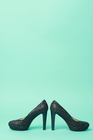 beautiful black heels in turquoise backgroundの写真素材