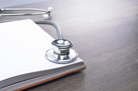 Stethscope on top of notebookの写真素材