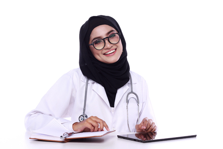 muslimah doctor holding a stethoscope isolated in white backgroundの写真素材