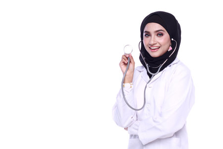 muslimah doctor holding a stethoscope isolated in white backgroundの写真素材