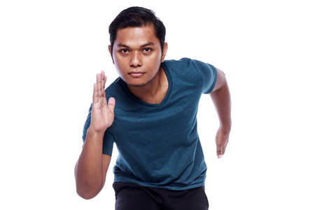 closed up young man sprinting isolated on white backgroundの写真素材