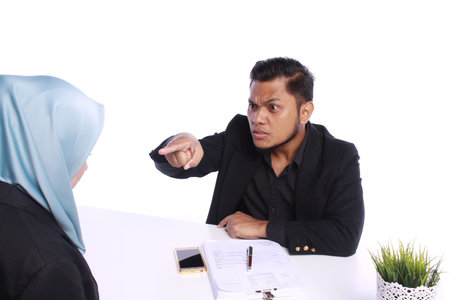 Angry boss firing female colleague by showing  his forefingerの写真素材