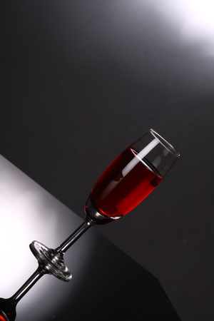 luxury red wine in champagne flute on grey backgroundの写真素材