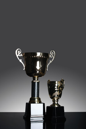 Gold trophy shoot isolated with gray gradient background in the studio.の写真素材