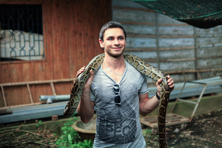 Ho Chi Minh City, Vietnam - 1 January 2018. Tourist holding a large snake at Mekong Delta tours.のeditorial素材