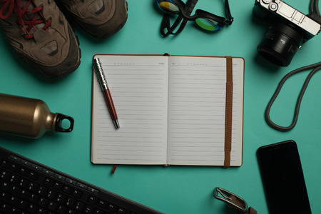 travel flat lay on turquoise backgroundの写真素材