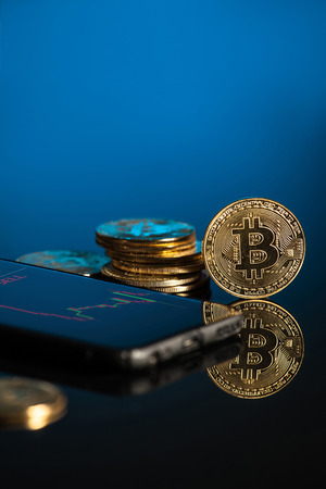 bitcoin with blue background technology with tablet and smartphone の写真素材