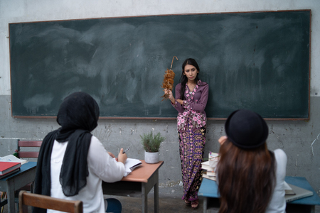 a teacher is teaching student in a classroom with multiple expessionsの写真素材