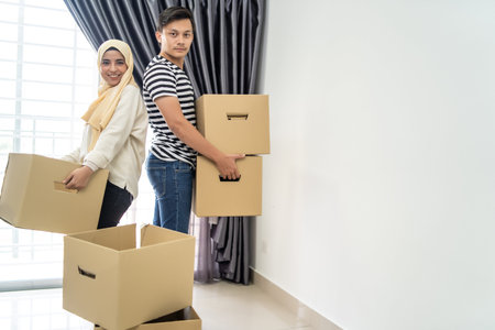 asian couple moving house together with box