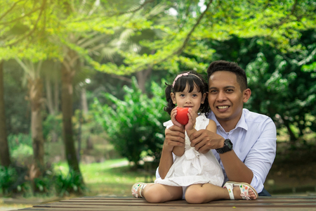 asian dad with doughter holding a hearth shapeの写真素材